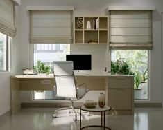 an office with a desk, computer monitor and chair in the middle of the room