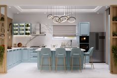 a kitchen with blue cabinets and white counter tops